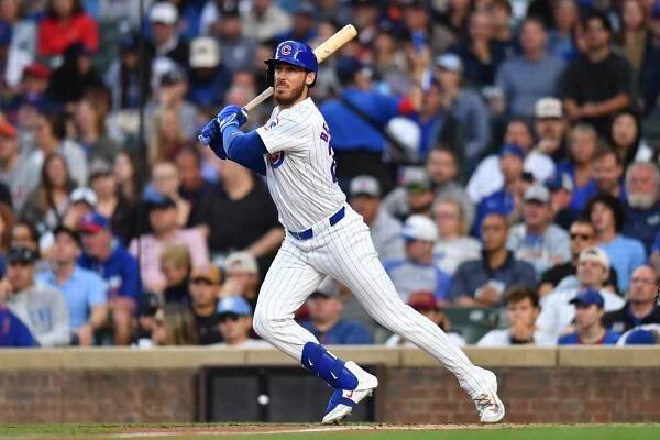 Chicago Cubs right fielder Cody Bellinger (24) hits a single during the first inning against the Detroit Tigers at Wrigley Field.