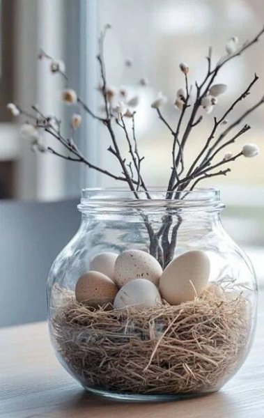 a glass jar filled with eggs sitting on top of a table