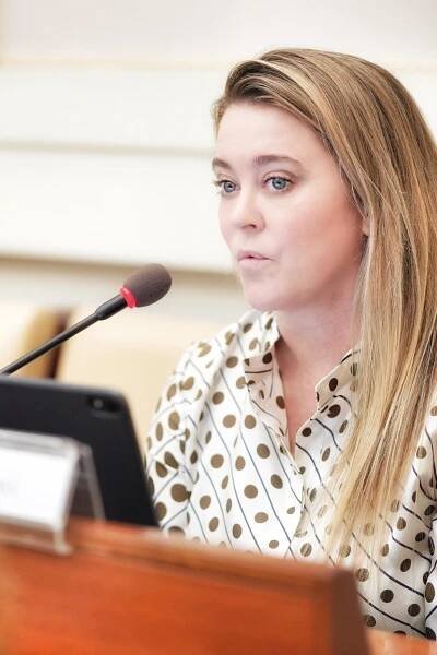Jennifer Gross, Co-Founder of the Blue Chip Foundation, speaking into a mic at a meeting