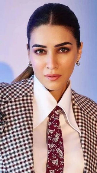 Kriti Sanon aces power dressing ina black gingham three-piece suit with a burgundy tie