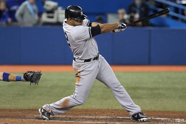 Yankees outfielder Vernon Wells rips a two-run double in the eighth inning against the Blue Jays.