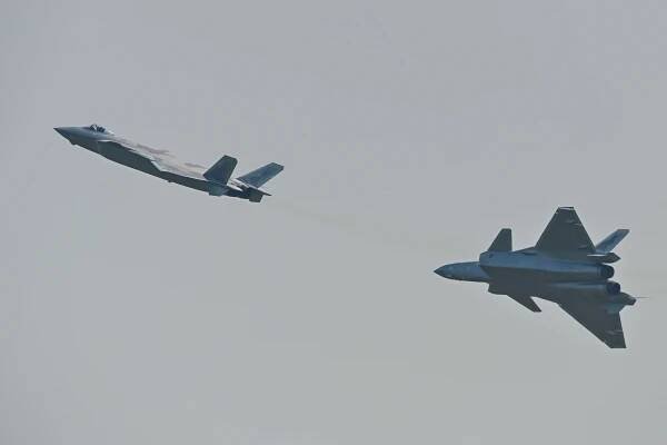 Photograph of two Chengdu J-20 stealth fighters at an air show.