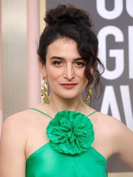 Jenny Slate with a curly updo in a green dress