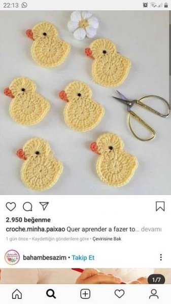 several crocheted ducks sitting on top of a table next to scissors and flowers