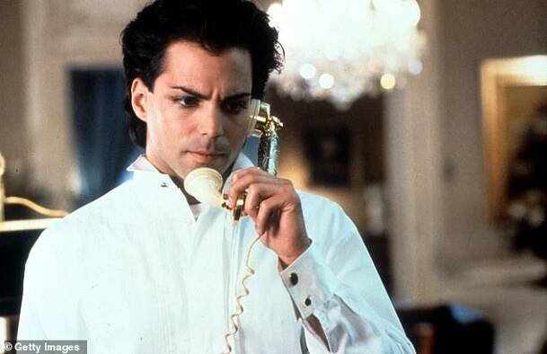The star wearing black eyeliner, with a phone receiver to his ear in a scene from the film If Looks Could Kill in 1991
