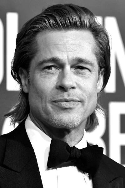 Image may contain Brad Pitt Suit Coat Clothing Overcoat Apparel Human Person Face Tie Accessories and Accessory