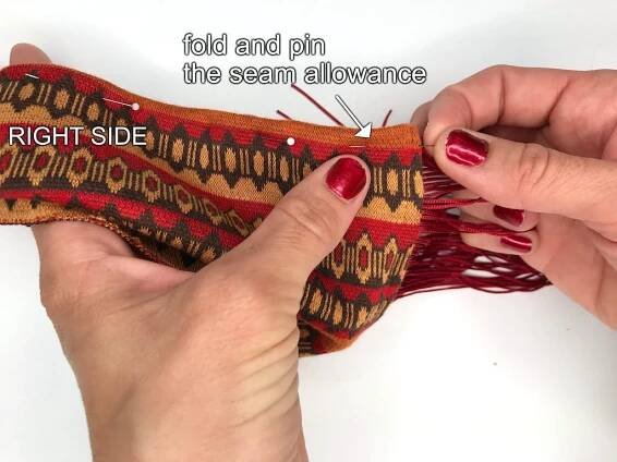 Pinning a folded seam allowance of a costume headband.