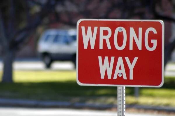 A wrong way sign on the highway