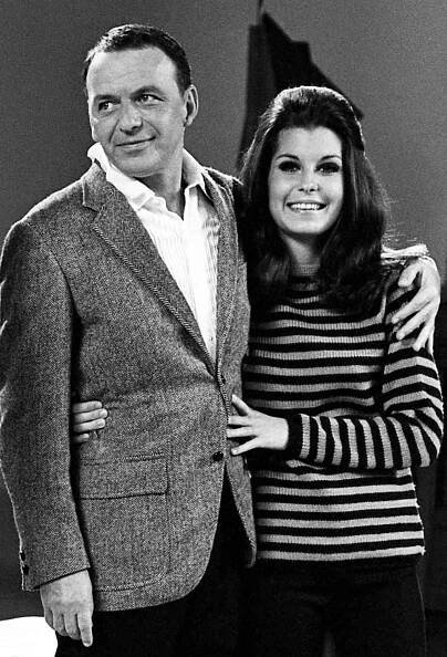 Frank Sinatra (1915-1998) and Tina Sinatra sing on stage during the taping of 'The Dean Martin, Frank Sinatra Christmas Special' circa December, 1967 in Los Angeles, California.