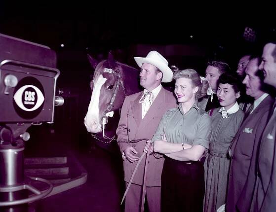 From left: Gene Autry's horse, Champion, Gene Autry, and Joan Caulfield at CBS Television City, the worlds largest studio complex built exclusively for television broadcasting at the time, and the shooting location for Caulfield's upcoming show, MY FAVORITE HUSBAND. March, 1953, Los Angeles, CA