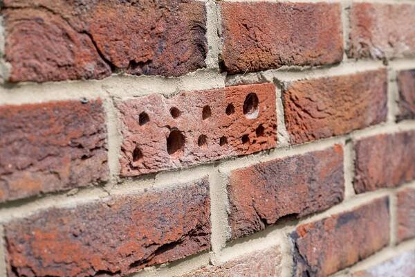 a brick wall with holes in it