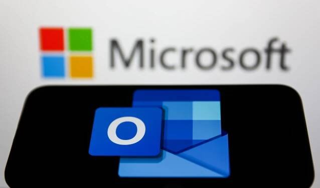 Illustration of the Microsoft Outlook logo on a phone screen with the Microsoft logo blurred in the background.