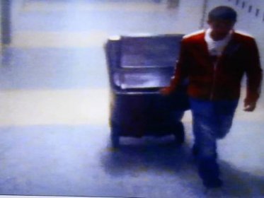 A video frame grab shown by defense attorney Denise Regan shows Philip Chism wheeling a large garbage can in a hall of Danvers High School, in the trial of Chism for the murder of Danvers High School teacher, Colleen Ritzer, in Salem Superior Court on Monday, Nov. 23, 2015. (Mark Lorenz/The Boston Globe via AP, Pool)