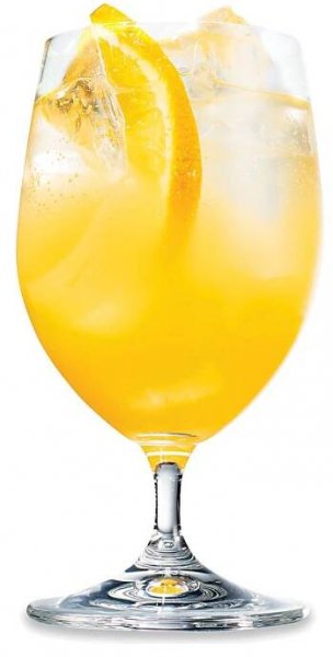A goblet of orange juice Cointreau and seltzer with an orange wheel garnish.