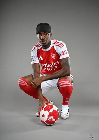 Noni Madueke in Arsenal kit with soccer ball.