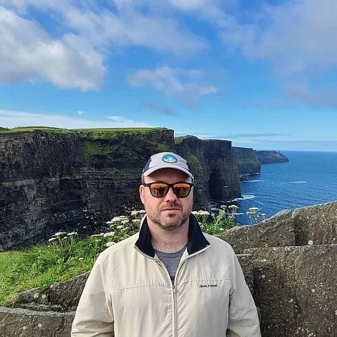 Mike Frederick, senior software engineer, focused on infrastructure. In this photo, he is at the Cliffs of Moher, Ireland.