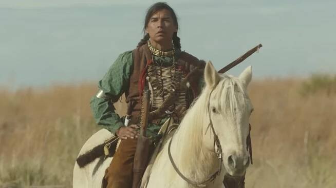 Two Feathers rides a horse