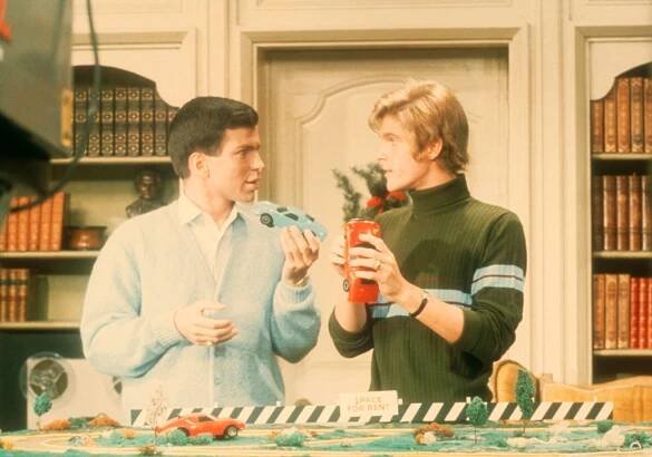 Frank Sinatra Jr. and Dean Paul Martin showing each other model cars