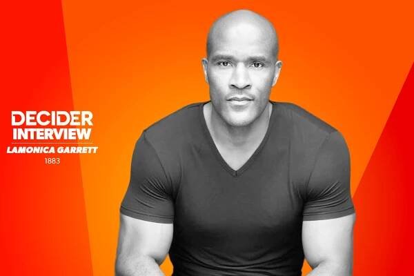 LaMonica Garrett in black and white in front of a bright orange background