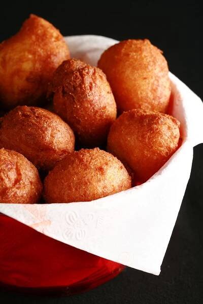 A bowl of gluten-free hushpuppies - little balls of deep fried cornmeal dough.