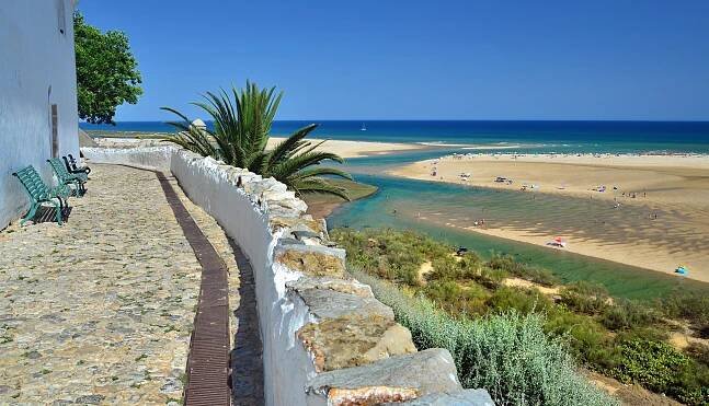 a view of a beach with a river running through it