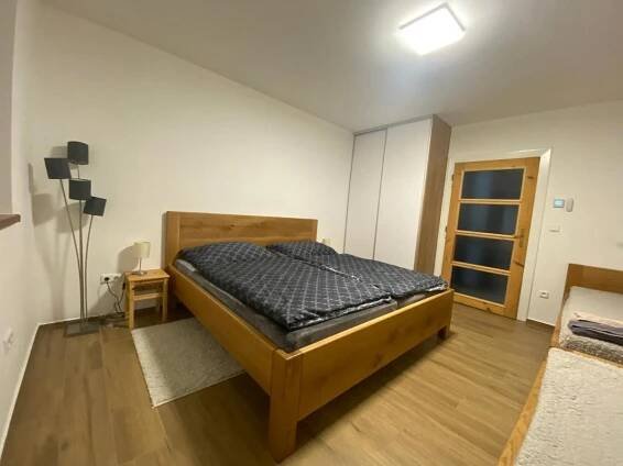 a bedroom with a wooden bed in a room at Vila Kosmonautka - Velké Losiny in Velké Losiny