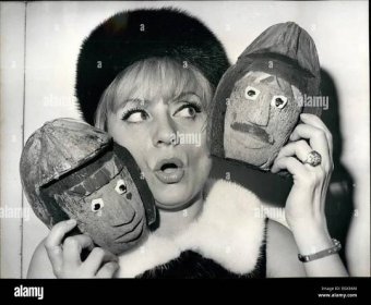 Mar. 03, 1965 - Annie Cordy awarded prize for humour: Annie Cordy, the famous radio and cabaret singer, was awarded the prize for humour. Photo shows Annie Cordy with her trophy, two masks painted on coconuts. Stock Photo
