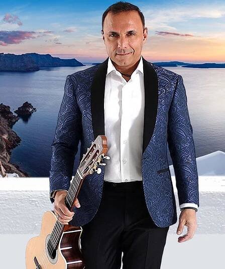 Pavlo, a Greek world music guitarist, holding his guitar looking into the camera
