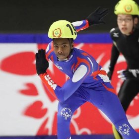 A Special Olympics USA speed skater races during the 2017 Special Olympics World Games in Austria as a competitor from Japan looks on.