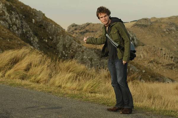 Colin Wright pretending to hitchhike in New Zealand. Photo by Kurt Langer.