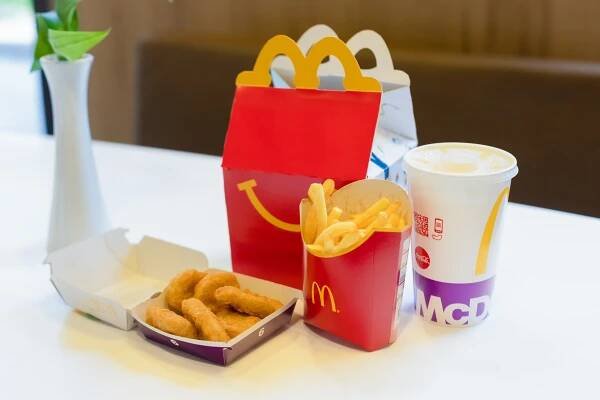 Happy Meal menu displayed at a McDonald's restaurant in Salzburg, Austria - with a cheeseburger, drink, and chicken McNuggets.