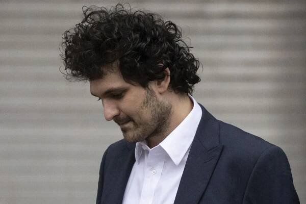 CORRECTS DATE TO THURSDAY - FTX founder Sam Bankman-Fried leaves court following his extradition to the U.S., Thursday, Dec. 22, 2022, in New York. Bankman-Fried's parents agreed to sign a $250 million bond and keep him at their California home while he awaits trial on charges that he swindled investors and looted customer deposits on his FTX trading platform. (AP Photo/Yuki Iwamura)