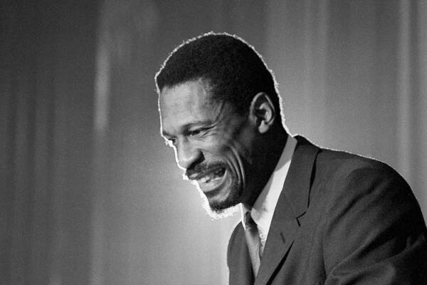 Russell grins at the announcement that he had been named coach of the Boston Celtics in April 1966