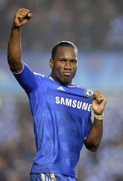 a soccer player holding his fist up in the air