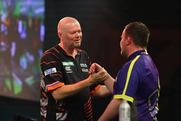 Raymond van Barneveld and Luke Littler shaking hands before a darts match.