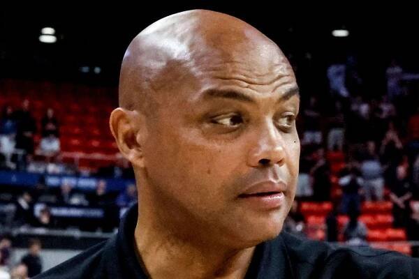 Charles Barkley gets heckled by a fan in public and he has to be restrained to prevent a fight