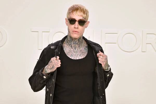 Trace Cyrus poses for a photo at the Tom Ford AW/20 Fashion Show