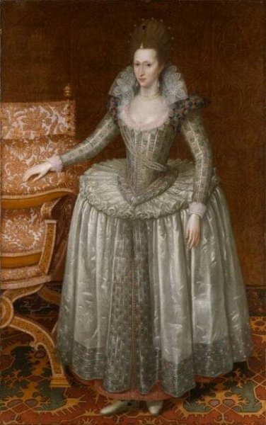 A portrait of a woman wearing an elaborate dress with her hand resting on a chair.