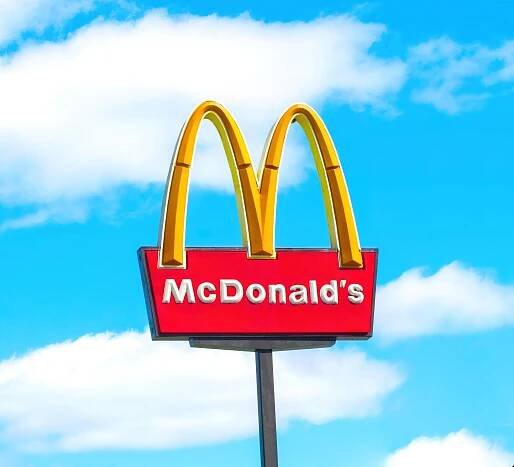 McDonald's logo against a blue sky.