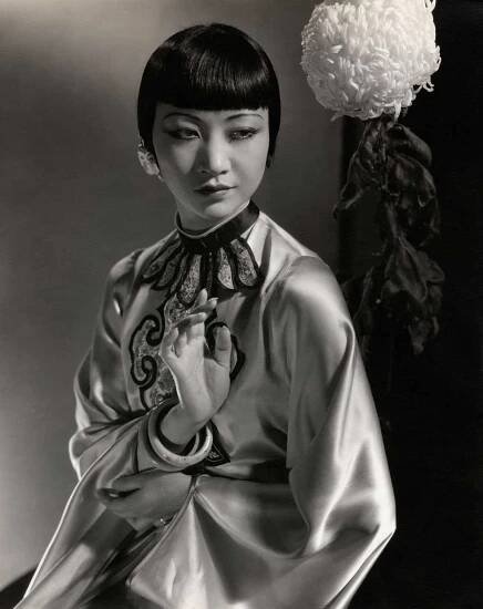 Actress Anna May Wong wearing an embroidered Chinese lounging robe in silk satin