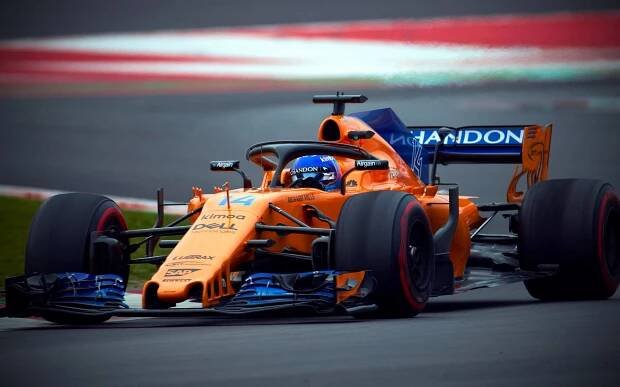 Caption: Fernando Alonso Racing in Orange McLaren Wallpaper