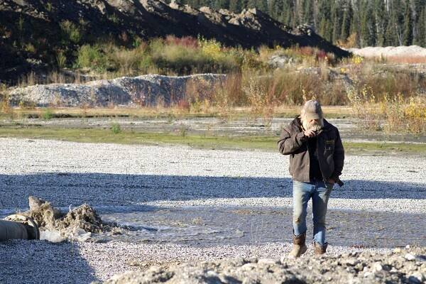 Tony Beets walking away from water pipe gushing water