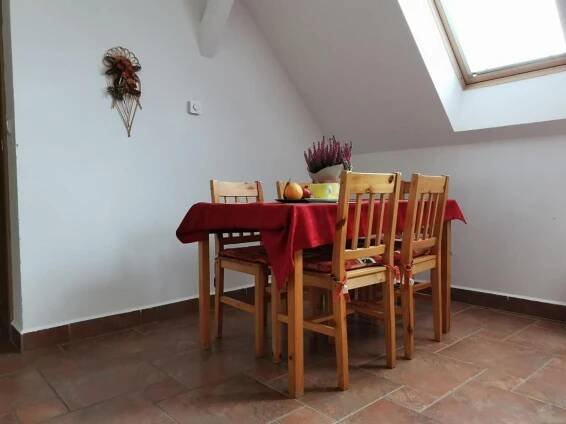 a dining room table and chairs with a red table cloth at Penzion Mia in Dolní Moravice