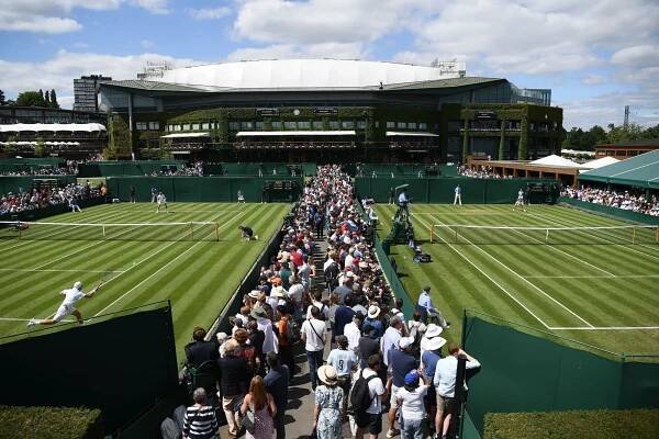 Fans walk towards centre court at The Championships, Wimbledon