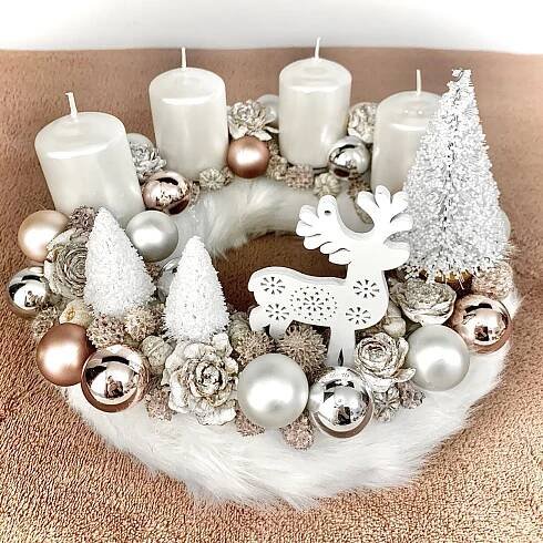 a christmas wreath with candles and ornaments