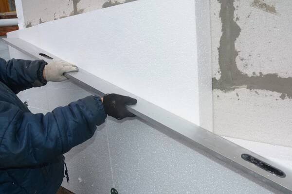 External wall foam board insulation. A building contractor is installing rigid polystyrene, styrofoam insulation to the house wall and is using a spirit level, What is the Thickest Foam Board Insulation