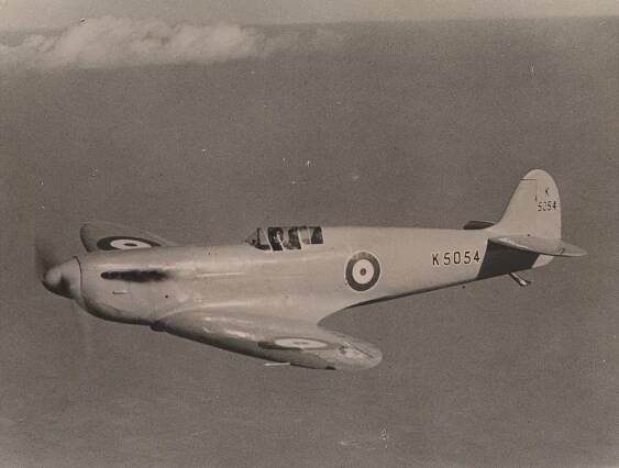 Black and white photo of a Spitfire airplane in flight.