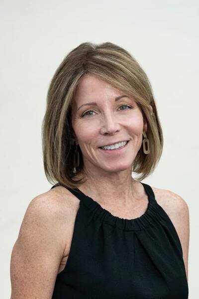 Julie Goldberg with bob haircut smiling.