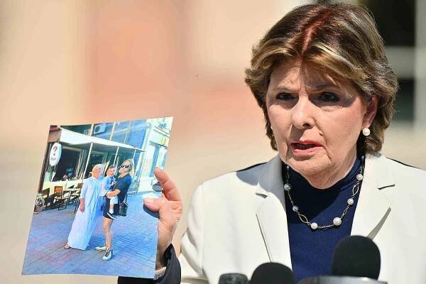 Gloria Allred, attorney for Halyna Hutchins' family, holds up a photos of Hutchins (R) holding her son Andros while standing next to her mother, Olga Solovey, and her son as she addresses the media regarding the dismissal of the criminal case against actor Alec Baldwin in front of the First Judicial District Court on July 13, 2024 in Santa Fe, New Mexico. The trial for involuntary manslaughter was dismissed by Judge Mary Marlowe Sommer on Friday, July 12, 2024 after she ruled that key evidence over a fatal shooting on the set of 