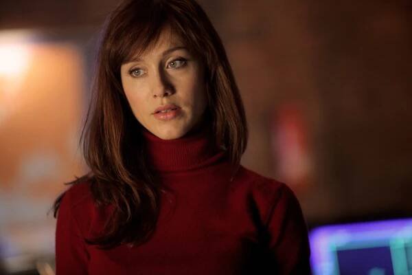 Gabriella Pession in a red top in "Crossing Lines"